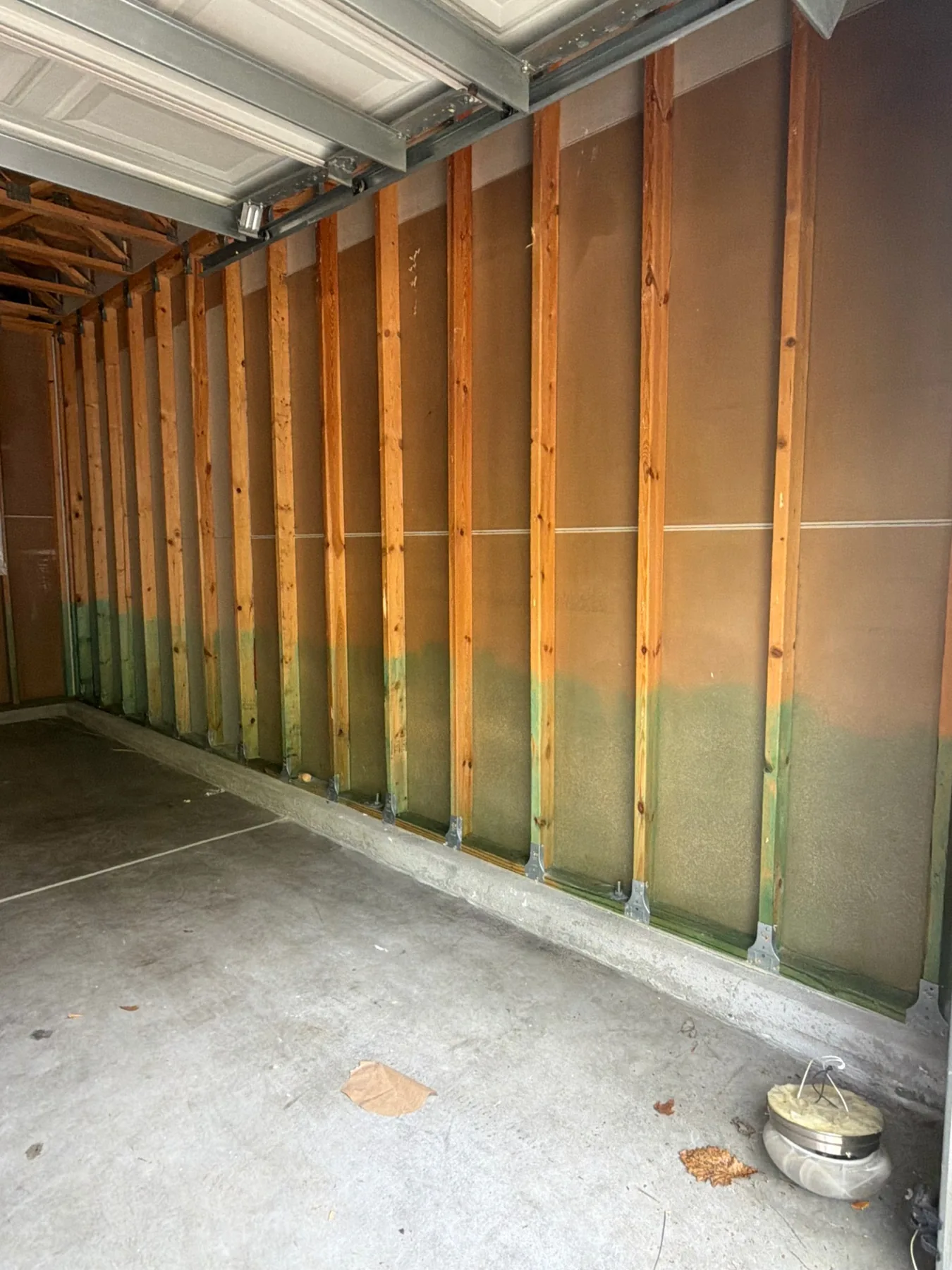 Garage wall framing prepared for insulation and restoration work