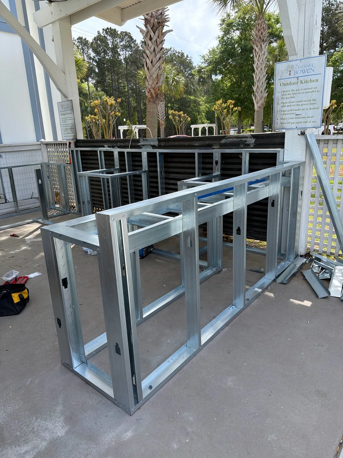 Metal framing for an outdoor kitchen build under a covered patio